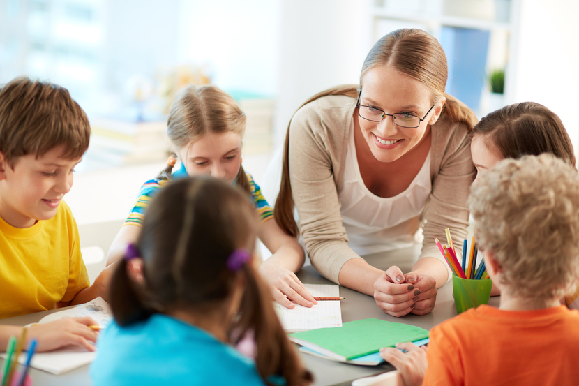 professora feliz com seus alunos na volta às aulas